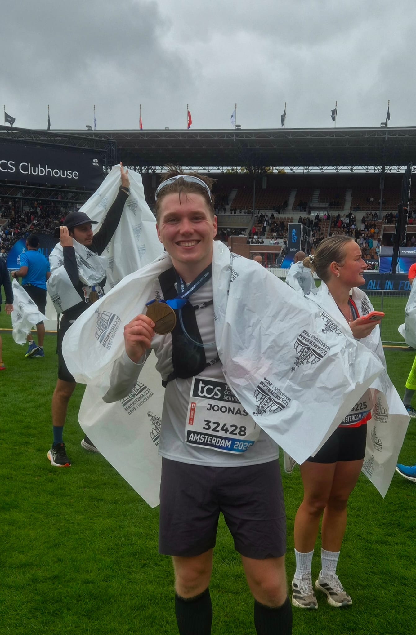 Joonas holding his finisher’s medal at the Amsterdam Marathon.