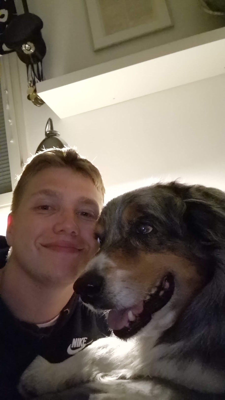 Joonas taking a close-up photo with a dog.
